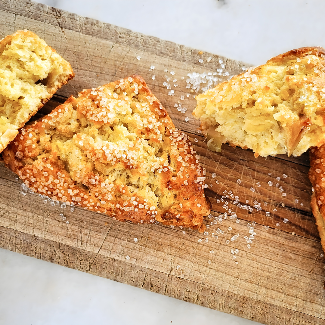 Sliced scones on a wooden board with a white background