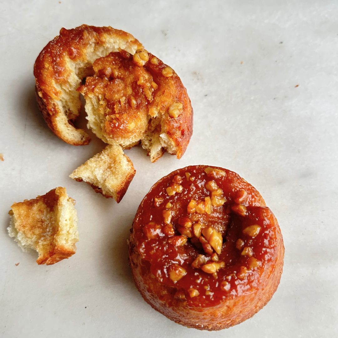 sticky bun with nuts on a marble surface